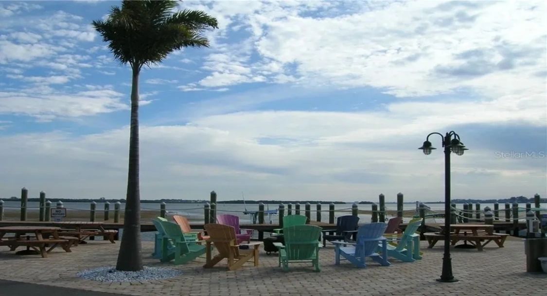 Sandpiper Resort marina and bayside area with colorful Adirondack chairs on Anna Maria Island